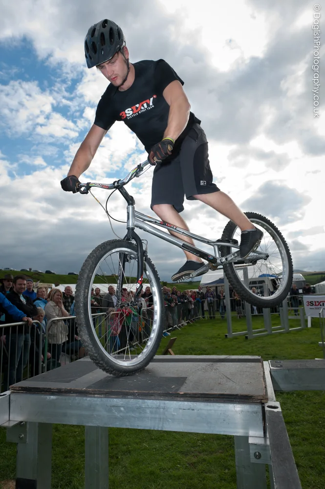 3SIXTY rider on a portable stunt rig with spectators behind